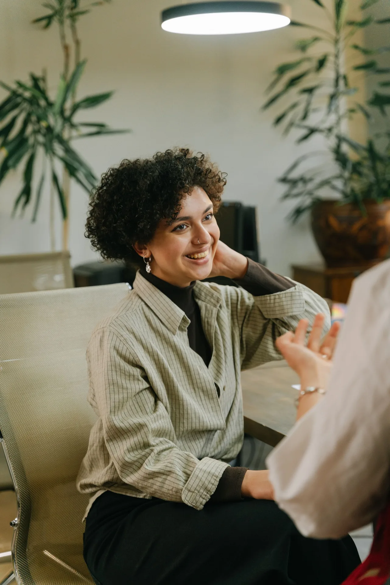 Practitioner in a thoughtful one-on-one session with a client